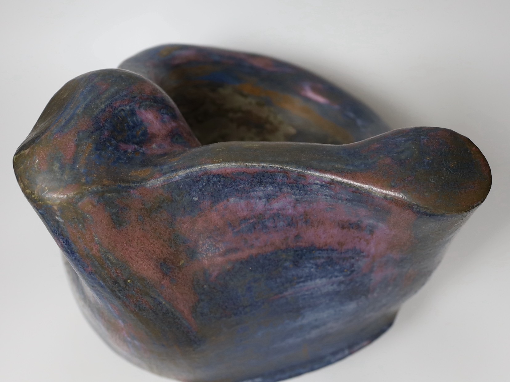 Ruth Sulke - a large studio purple and indigo nickel oxide glazed stoneware bulbous sculpture with flowing lines and hollows, 1985, 34cm, See Sulke, Ruth - Ceramic Sculpture by Ruth Sulke, Hanart 2 Gallery, 1987, page 24